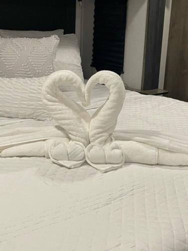 two swans making a heart on a bed at Downtown Dade City Glamper in Dade City