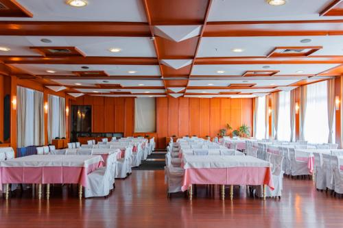 a large banquet hall with white tables and chairs at Hotel Saraj in Sarajevo