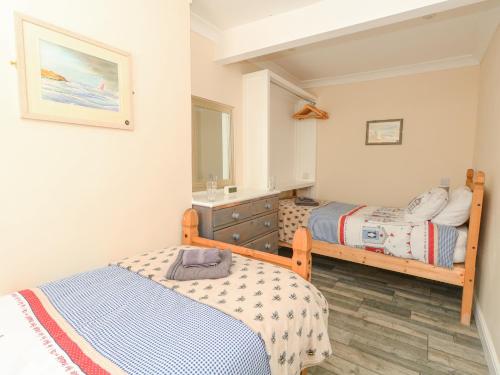 a bedroom with two beds and a mirror at Home From Home in Portland