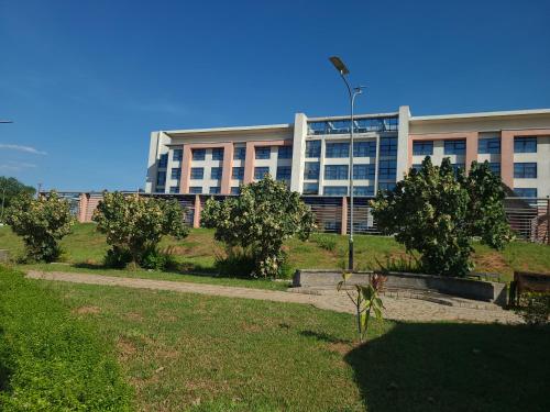 a large building with trees in front of it at Agulu Lake Resort and Conference Centre in Ekwulobia