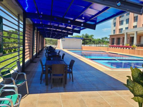 a patio with tables and chairs next to a pool at Agulu Lake Resort and Conference Centre in Ekwulobia