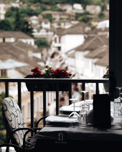 a table with chairs and a view of a city at Hotel Cajupi in Gjirokastër