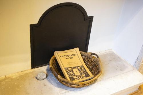 a book sitting in a basket on a counter at Welcomely - Burlamacchi House in Lucca