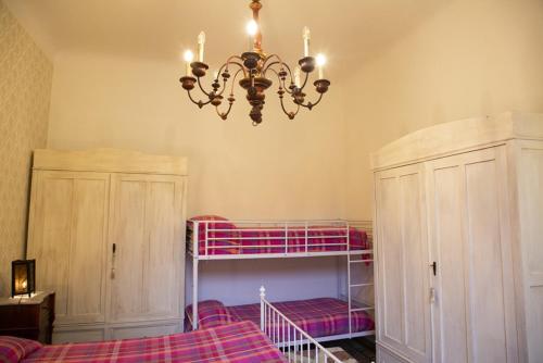 a bedroom with a bunk bed and a chandelier at Welcomely - Burlamacchi House in Lucca