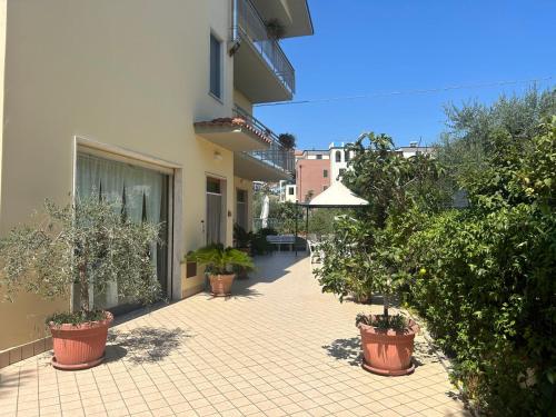 a courtyard with potted plants and a building at Pensione Vagnozzi in Grottammare
