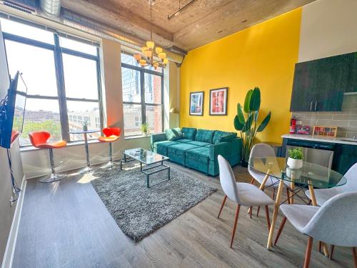 a living room with a green couch and a table at Spacious South Loop 2BR Apartment Near McCormick Place, Soldier Field & Downtown Chicago in Chicago