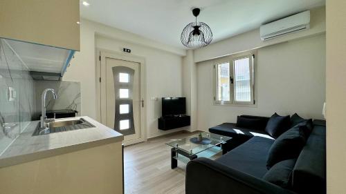 a living room with a couch and a kitchen at Tresor Apartments in Parga