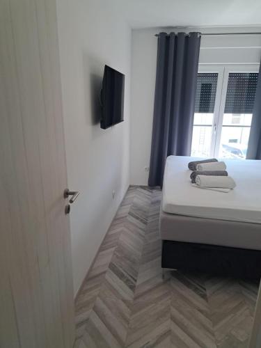a bedroom with a bed and a tv on the wall at Villa Zdenko in Omiš