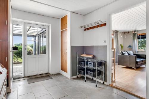 an open living room with a door leading to a living room at Hyggeligt byhus i Bonnet in Lemvig