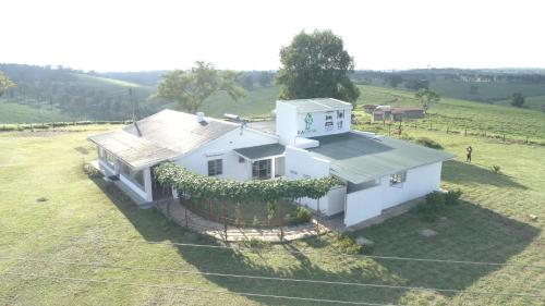 an overhead view of a white house in a field at KaChai Hotel Fort Portal in Kyarusozi