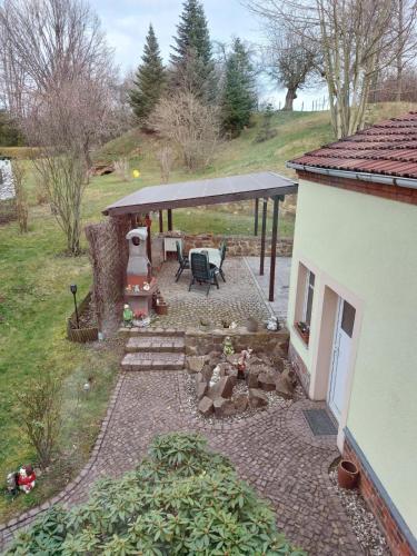 a backyard with a patio with a table and a pavilion at Ferienwohnungen im Herzen Sachsens in Döbeln