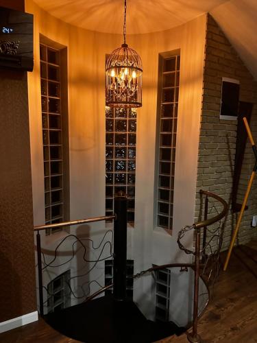 a chandelier in a room with a wine cellar at The Residence Central Jacuzzi Boutique (Adult Only) in Cluj-Napoca
