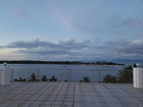 a view of a body of water with a fence at Islandview Whitehouse - Camotes in Esperanza