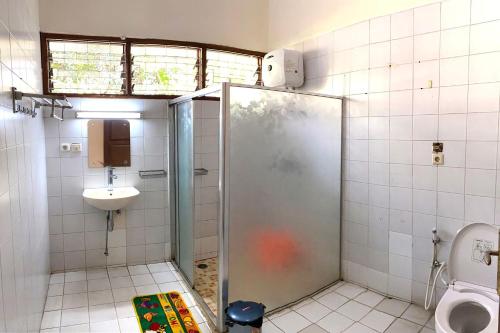 a bathroom with a shower and a sink and a toilet at Nataka Green in Kopo 2