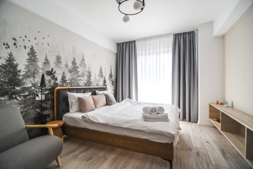 a bedroom with a bed with a christmas tree mural at Forest View Hideaway in Braşov
