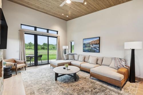 a living room with a couch and a table at Mara Luxury Cabins- Ponderosa in Hamilton