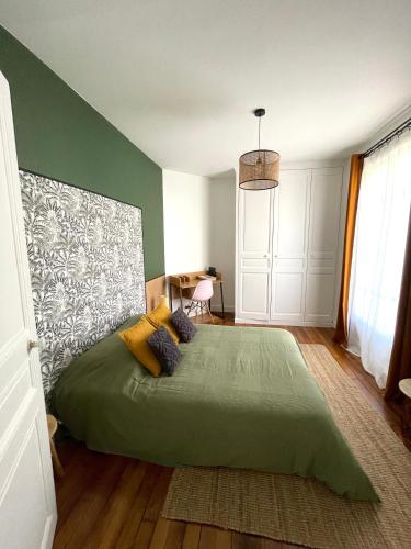 - une chambre avec un grand lit vert dans l'établissement Havre de paix moderne, fibre,RER B direction Paris, à Fontenay-aux-Roses