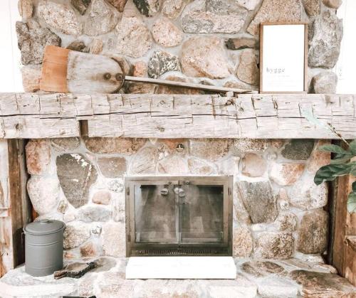 a stone wall with a laptop sitting on a mantle at Cellar Suite at Winery and Vineyard in Waterford
