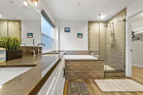 a bathroom with a shower and a sink and a tub at Luxurious 4BR in prime LA location with great view in Los Angeles