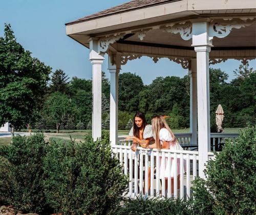 two women are standing on a gazebo at Cellar Suite at Winery and Vineyard in Waterford