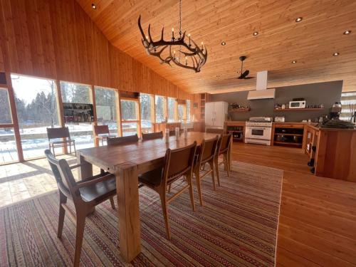 a dining room with a large wooden table and chairs at The Skwala Lodge in Darby