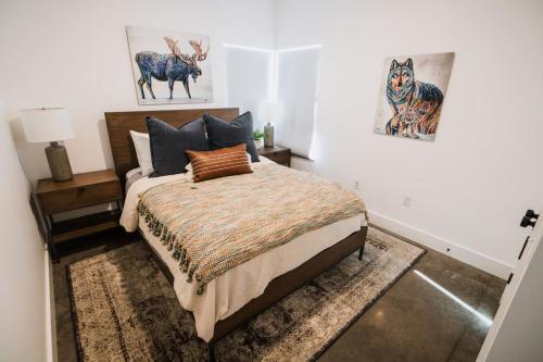 a bedroom with a bed and a picture of a deer at Modern Missoula Bungalow in Missoula