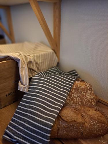 a loaf of bread and a striped towel on a table at Hotell Rådhuset in Lidköping