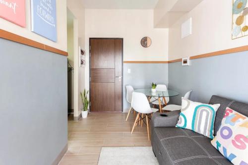 a living room with a couch and a table at The Sweet Escape 1 BR w Pool, Sauna, Gym and More in Manila