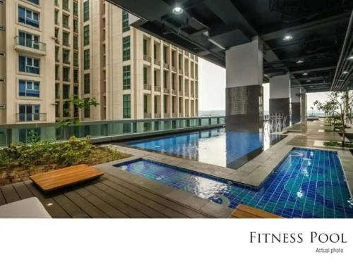 a swimming pool in the middle of a building at The Sweet Escape 1 BR w Pool, Sauna, Gym and More in Manila