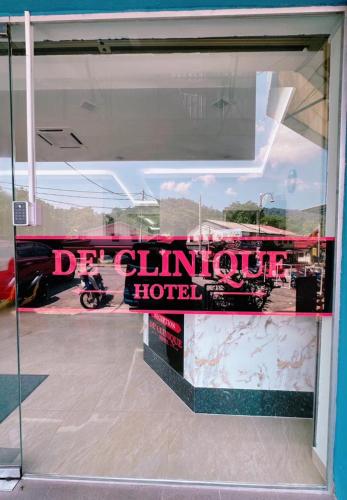a window of a hotel with a sign on it at De Clinique Hotel in Pangkor