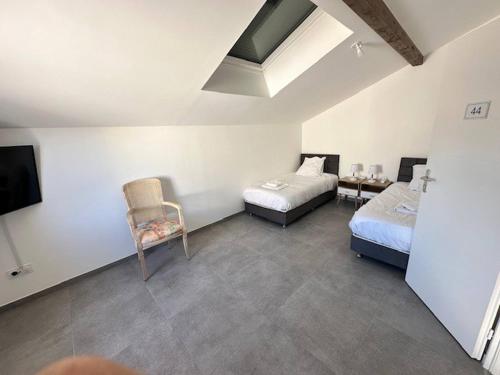 - une chambre avec 2 lits, une télévision et une chaise dans l'établissement House 40 With 5 Bedrooms Lechaffardcom, à Satolas-et-Bonce