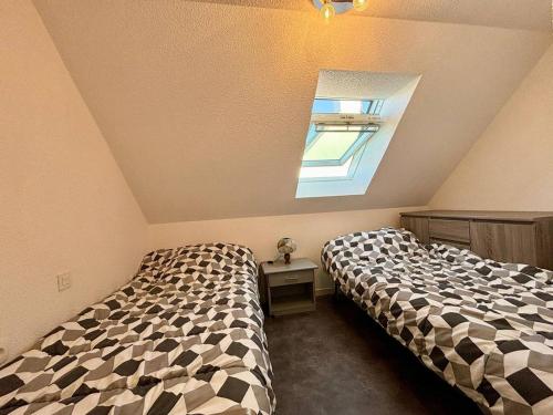 une chambre avec deux lits et une fenêtre dans l'établissement Maison à Carnac: 2 Chambres, 4 Couchages, Jardin, Parking, Proche Plage et Commerces - FR-1-377-46, à Carnac