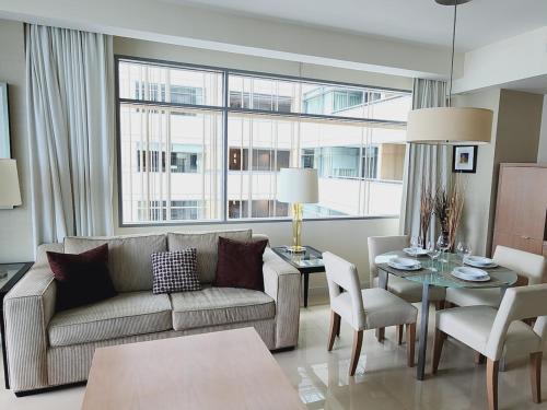 a living room with a couch and a table at Lux Aka Brickell Condo in Miami