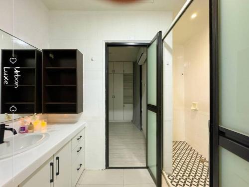 a bathroom with a shower and a sink and a mirror at NEW Event House OUG KL Spacious 18pax in Kuala Lumpur