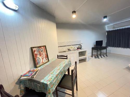 a living room with a table and a piano at Impact Arena C3 Milo in Nonthaburi