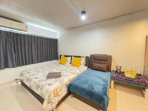 a bedroom with a large bed and a chair at Impact Arena C3 Milo in Nonthaburi