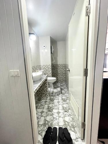 a bathroom with a sink and a toilet and a sink at Impact Arena C3 Milo in Nonthaburi