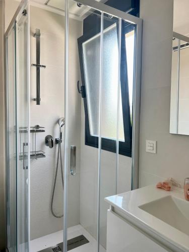 a bathroom with a shower and a sink at Air-conditioned Elisa Apartment with spacious sunroof lounge and swimming pool in San Javier