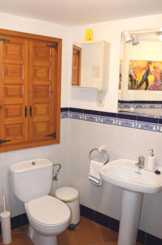 a bathroom with a toilet and a sink at Casa Toblerone in Oliva