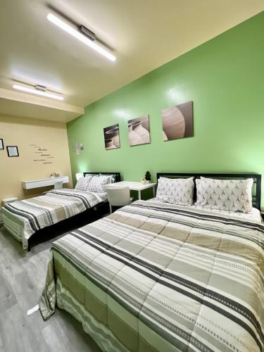 two beds in a room with green walls at Private Room Near Airport K6 in Mississauga