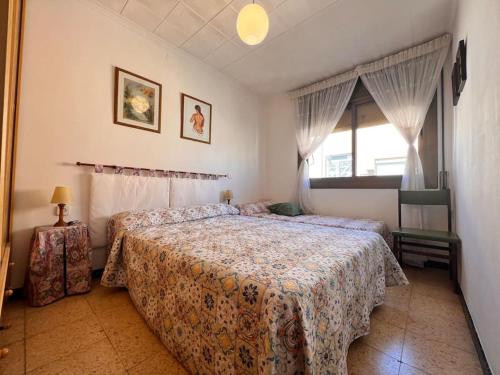 a bedroom with two beds and a window at Costa Cunit in Cunit