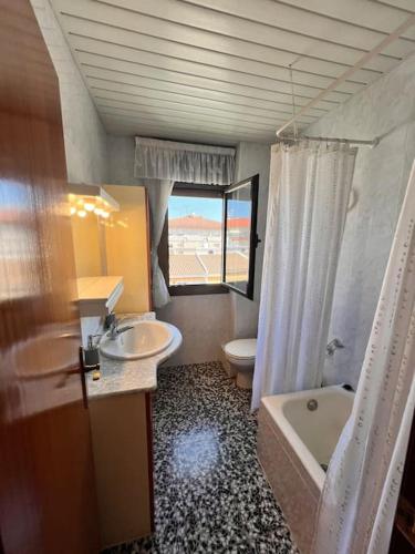a bathroom with two sinks and a tub and a toilet at Costa Cunit in Cunit