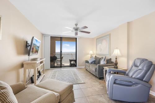 a living room with a couch and a chair at Compass Point 201 Pet-friendly for fee Boat ramp in Gulf Shores