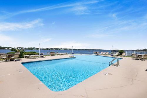 a swimming pool with a view of the water at Compass Point 201 Pet-friendly for fee Boat ramp in Gulf Shores