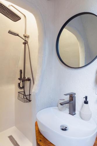 a bathroom with a sink and a mirror at Rustic Inn bed and breakfast in Budeşti