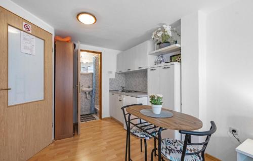 a kitchen with a table and chairs in a room at Amazing Apartment In Vodice in Vodice
