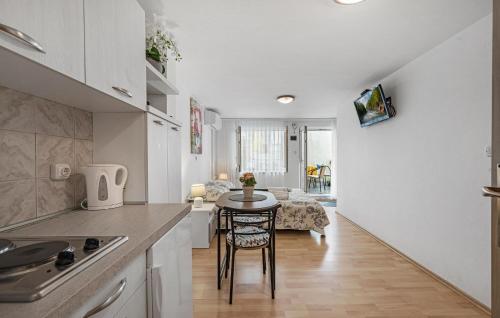 a kitchen with a table and a dining room at Amazing Apartment In Vodice in Vodice
