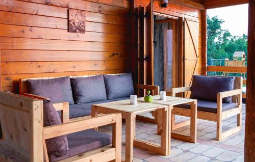 a porch with a couch and a table and chairs at 4 Bedroom Awesome Home In Vukovar in Vukovar