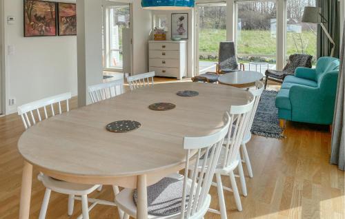 a dining room with a wooden table and chairs at Cozy Home In Kungsbacka in Kungsbacka