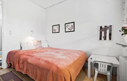 a white bedroom with a bed and a table at 4 Bedroom Lovely Home In Lemvig in Lemvig